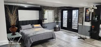 a bedroom with a large bed and a window at Staycation Oasis! a unique Experience! Heated pool open until November 1st in Easton