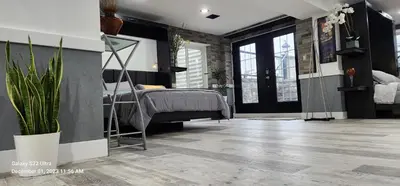 a bedroom with a bed and a plant at Staycation Oasis! a unique Experience! Heated pool open until November 1st in Easton