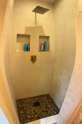 a bathroom with a shower with blue vases at Roscoe Pine House in Roscoe