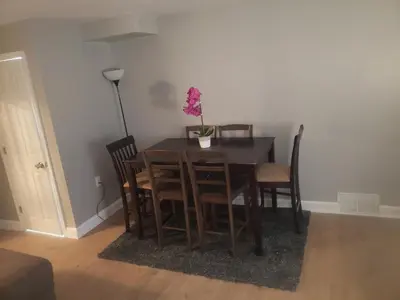 a dining room table and chairs with a plant on it at Orchard Room by the Airport - Shared Space in Darby