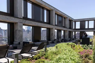 a view of a building with chairs and plants at Blueground LES gym doorman near market NYC-1523 in New York