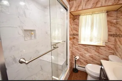a bathroom with a shower and a toilet at Cozy home away from home in Tobyhanna