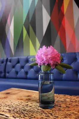 a vase with pink flowers sitting on a table at Warehouse Hotel at The Nook in Manheim
