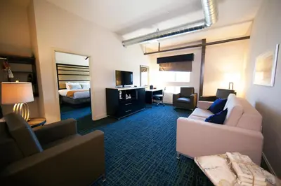 a living room with a couch and a bedroom at Warehouse Hotel at The Nook in Manheim