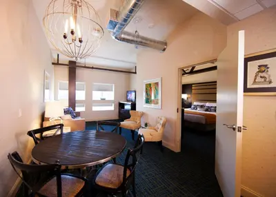 a room with a dining table and a living room at Warehouse Hotel at The Nook in Manheim