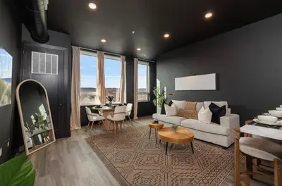 a living room with a couch and a table at Cozy 1 King BR, Gym, Free Parking, 8mins Train in East Orange