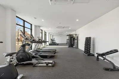 a gym with cardio machines and treadmills at Cozy 1 King BR, Gym, Free Parking, 8mins Train in East Orange
