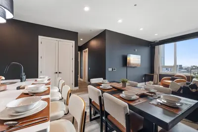 a dining room and living room with a table and chairs at 2BR 2BA, King bd, Gym, Free Parking, 8min to Train in East Orange