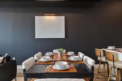 a dining room with a wooden table and chairs at 2BR 2BA, King bd, Gym, Free Parking, 8min to Train in East Orange