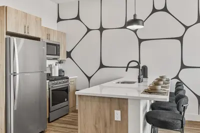 a kitchen with a refrigerator and a counter top at King Bd, Free Prkn, NYC View, 8min Train in East Orange