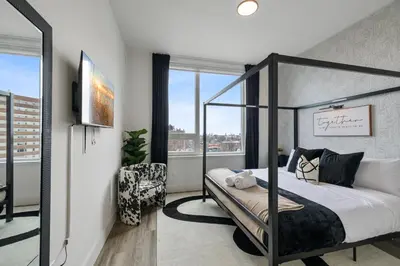 a bedroom with a canopy bed and a window at King Bd, Free Prkn, NYC View, 8min Train in East Orange