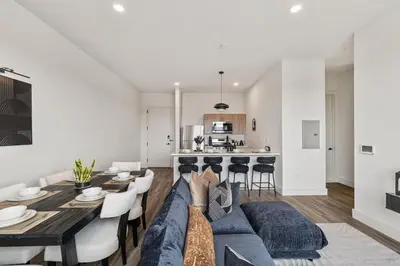 a person sitting on a couch in a living room at Upscale Views 2br Free Parkn, Walk 2 Train, 2bath in East Orange