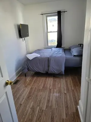 a bedroom with a bed and a window at Two-Bedroom Home 25 min to NYC Free parking-UNIT-1 in Teaneck