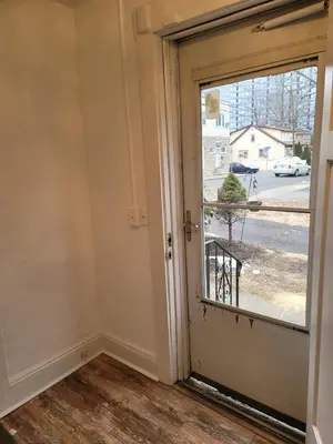 an empty room with a door and a window at Two-Bedroom Home 25 min to NYC Free parking-UNIT-1 in Teaneck