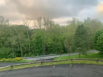 an empty road with a fence on the side of the road at Top floor modern country home in Northampton