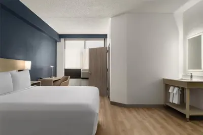 a bedroom with a large white bed and a desk at Hyatt Place Secaucus Meadowlands in Secaucus