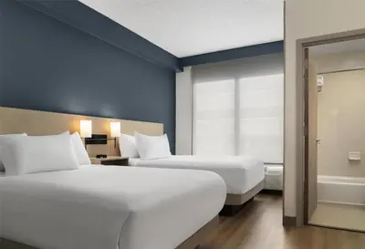a hotel room with two beds and a window at Hyatt Place Secaucus Meadowlands in Secaucus