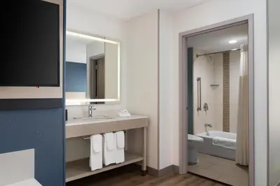 a bathroom with a sink and a toilet and a mirror at Hyatt Place Secaucus Meadowlands in Secaucus