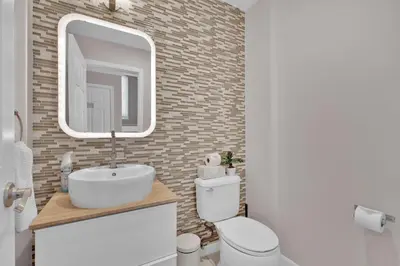 a bathroom with a white sink and a mirror at Oceanfront Villa - Panoramic NYC Views - Luxury Home in Keansburg