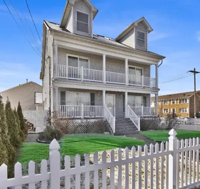a white fence in front of a house at Oceanfront Villa - Panoramic NYC Views - Luxury Home in Keansburg