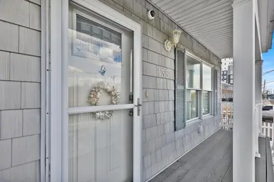 a white door on a house with a porch at Oceanfront Villa - Panoramic NYC Views - Luxury Home in Keansburg