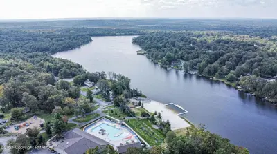 an aerial view of a river with a swimming pool at Whimsical Wilderness Lodge in Tobyhanna
