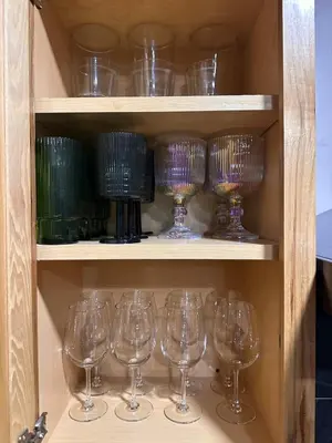 a bunch of wine glasses sitting on shelves at Whimsical Wilderness Lodge in Tobyhanna