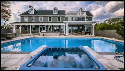 a large house with a swimming pool in front of it at Modern Farm Estate Close To Six Flags & Vineyard in Cream Ridge