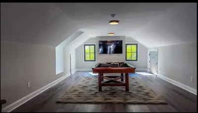 a living room with a table in the middle of a room at Modern Farm Estate Close To Six Flags & Vineyard in Cream Ridge