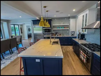 a large kitchen with blue cabinets and a counter top at Modern Farm Estate Close To Six Flags & Vineyard in Cream Ridge