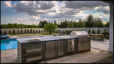 an outdoor kitchen with a grill on a patio at Modern Farm Estate Close To Six Flags & Vineyard in Cream Ridge