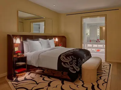 a bedroom with a large bed and a mirror at Faena New York in New York