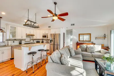 a living room with a couch and a kitchen at Hudson Valley Retreat with Pool Near Greenwood Lake in Monroe