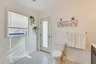 a bathroom with a toilet and a window at Hudson Valley Retreat with Pool Near Greenwood Lake in Monroe