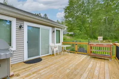 a deck with a table and chairs on a house at Hudson Valley Retreat with Pool Near Greenwood Lake in Monroe