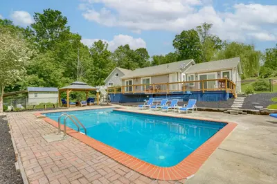 a swimming pool in front of a house at Hudson Valley Retreat with Pool Near Greenwood Lake in Monroe