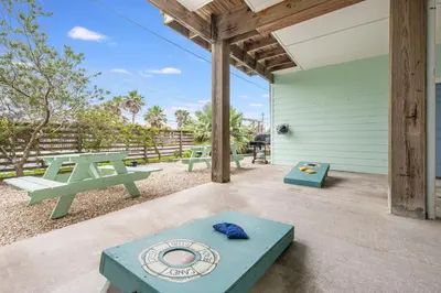 a patio with a picnic table and benches at Caney Creek Beach Club - Pet Friendly Golf Cart Included in Philadelphia
