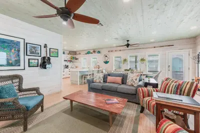 a living room with a couch and a table at Caney Creek Beach Club - Pet Friendly Golf Cart Included in Philadelphia