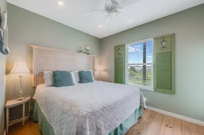 a bedroom with a bed and a ceiling fan at Caney Creek Beach Club - Pet Friendly Golf Cart Included in Philadelphia