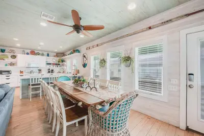 a kitchen with a wooden table and a ceiling fan at Caney Creek Beach Club - Pet Friendly Golf Cart Included in Philadelphia
