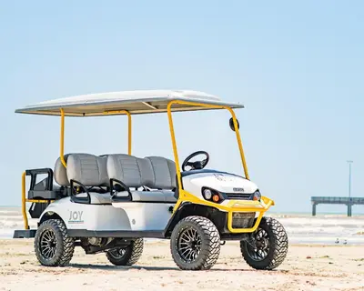 a yellow and white golf cart on the beach at Caney Creek Beach Club - Pet Friendly Golf Cart Included in Philadelphia