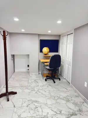an office with a desk and a chair on a marble floor at 2-Bedroom Sleeps 6 Stay Near EWR & American Dream in Newark