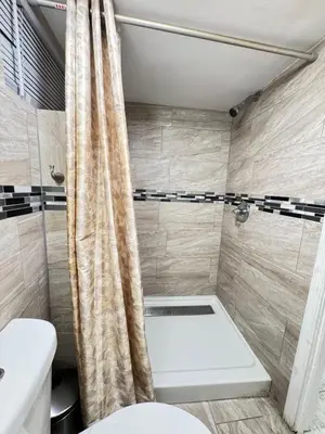 a bathroom with a toilet and a shower at 2-Bedroom Sleeps 6 Stay Near EWR & American Dream in Newark