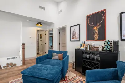 a living room with two blue chairs and a table at Luxury Getaway with Nature and Comfort in Albrightsville