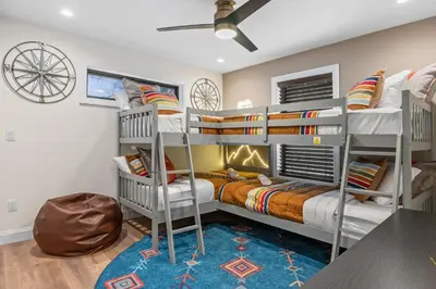a room with two bunk beds and a bed at Luxury Getaway with Nature and Comfort in Albrightsville