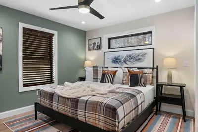 a bedroom with a bed and a ceiling fan at Luxury Getaway with Nature and Comfort in Albrightsville