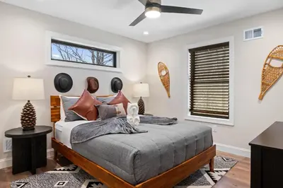 a bedroom with a bed and a ceiling fan at Luxury Getaway with Nature and Comfort in Albrightsville
