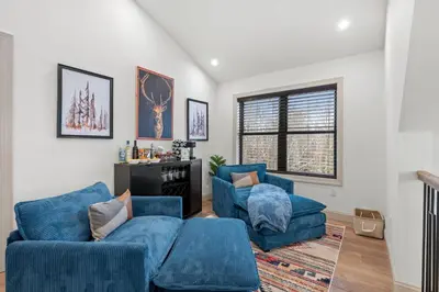 a living room with two blue chairs and a couch at Luxury Getaway with Nature and Comfort in Albrightsville