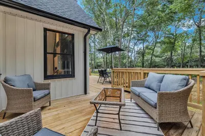 a patio with two chairs and a couch on a deck at Luxury Hot Tub Game Room and More in Albrightsville