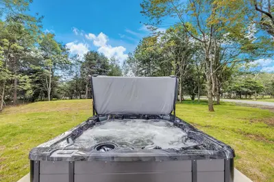 a hot tub in the middle of a park at Luxury Hot Tub Game Room and More in Albrightsville